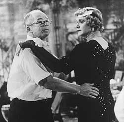 Billy Wilder shows Jack Lemmon how to cut a rug in full Daphyne garb
